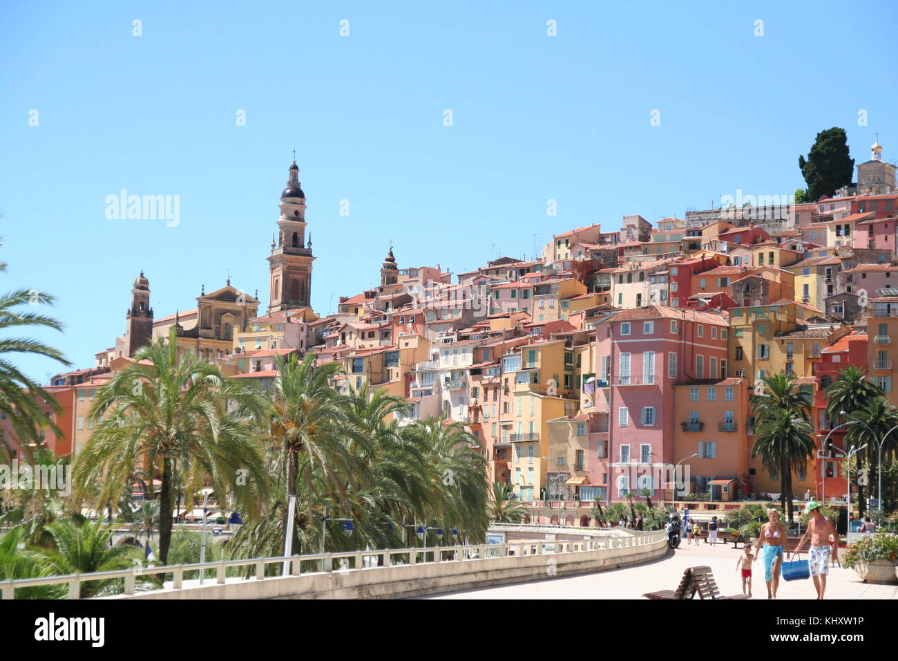 Family on Vacation enjoy a stroll along the promenade at Menton in the South of France. Stock Photo