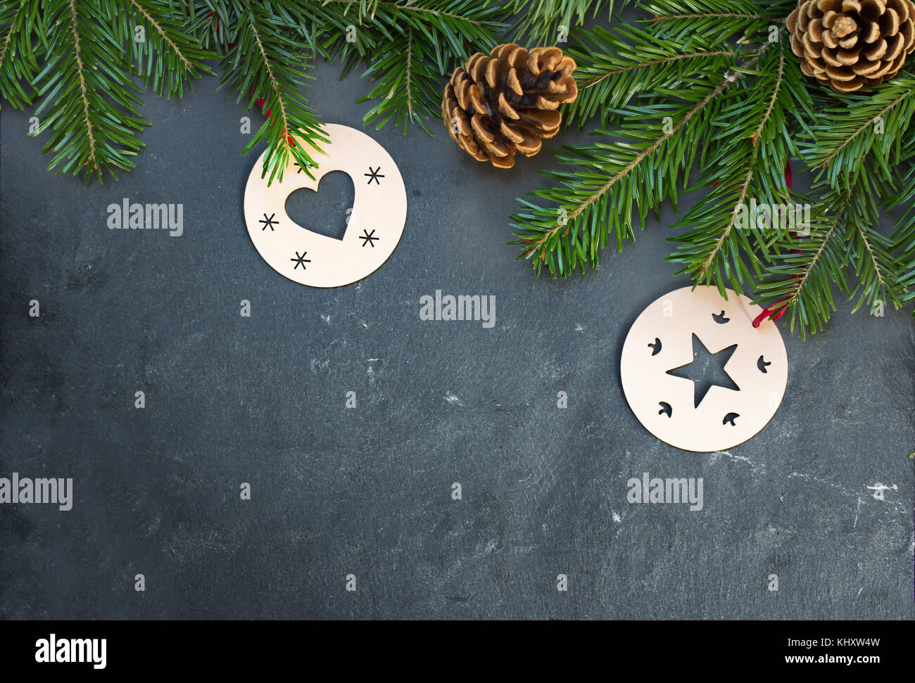 christmas decorations and fir branch on dark stone table Stock Photo