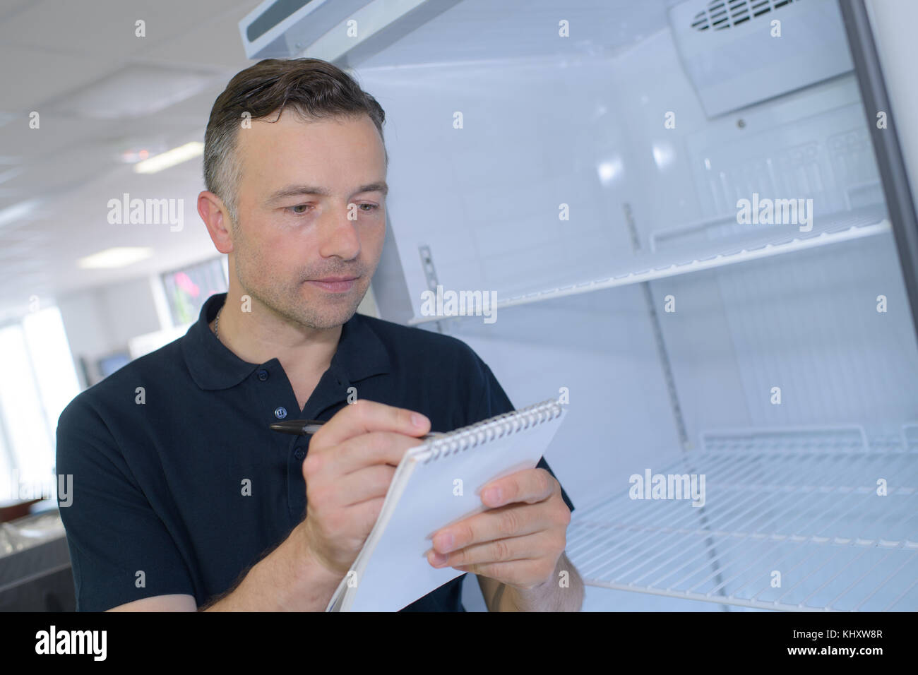man writing on sticky notes in office Stock Photo - Alamy