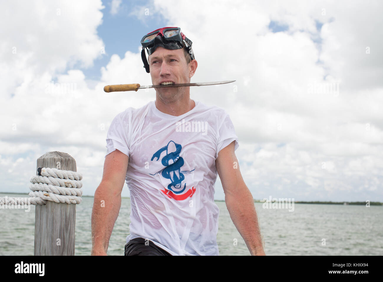 Man holding knife in mouth hires stock photography and images Alamy