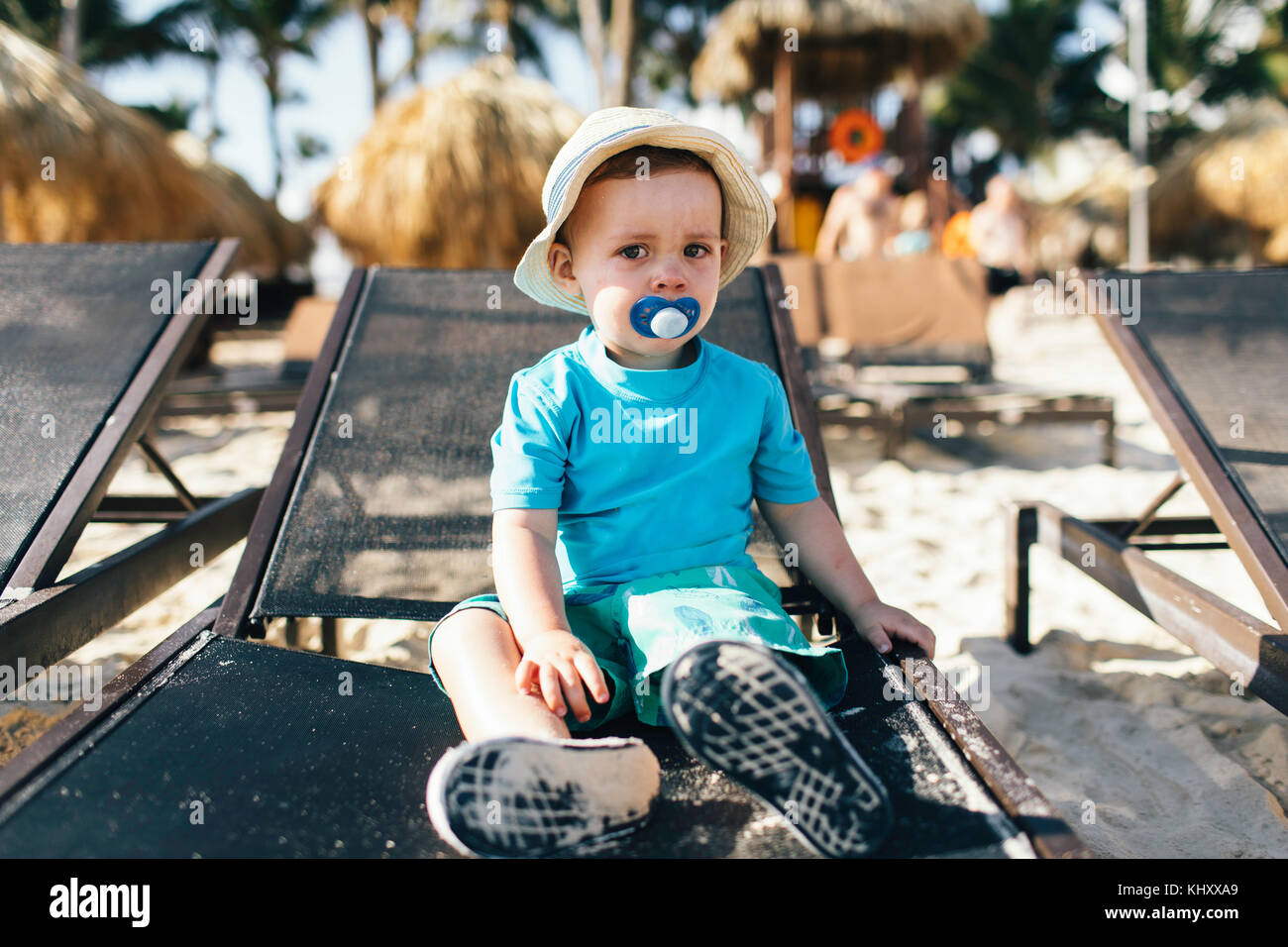 Portrait of young boy sitting on sun lounger Stock Photo
