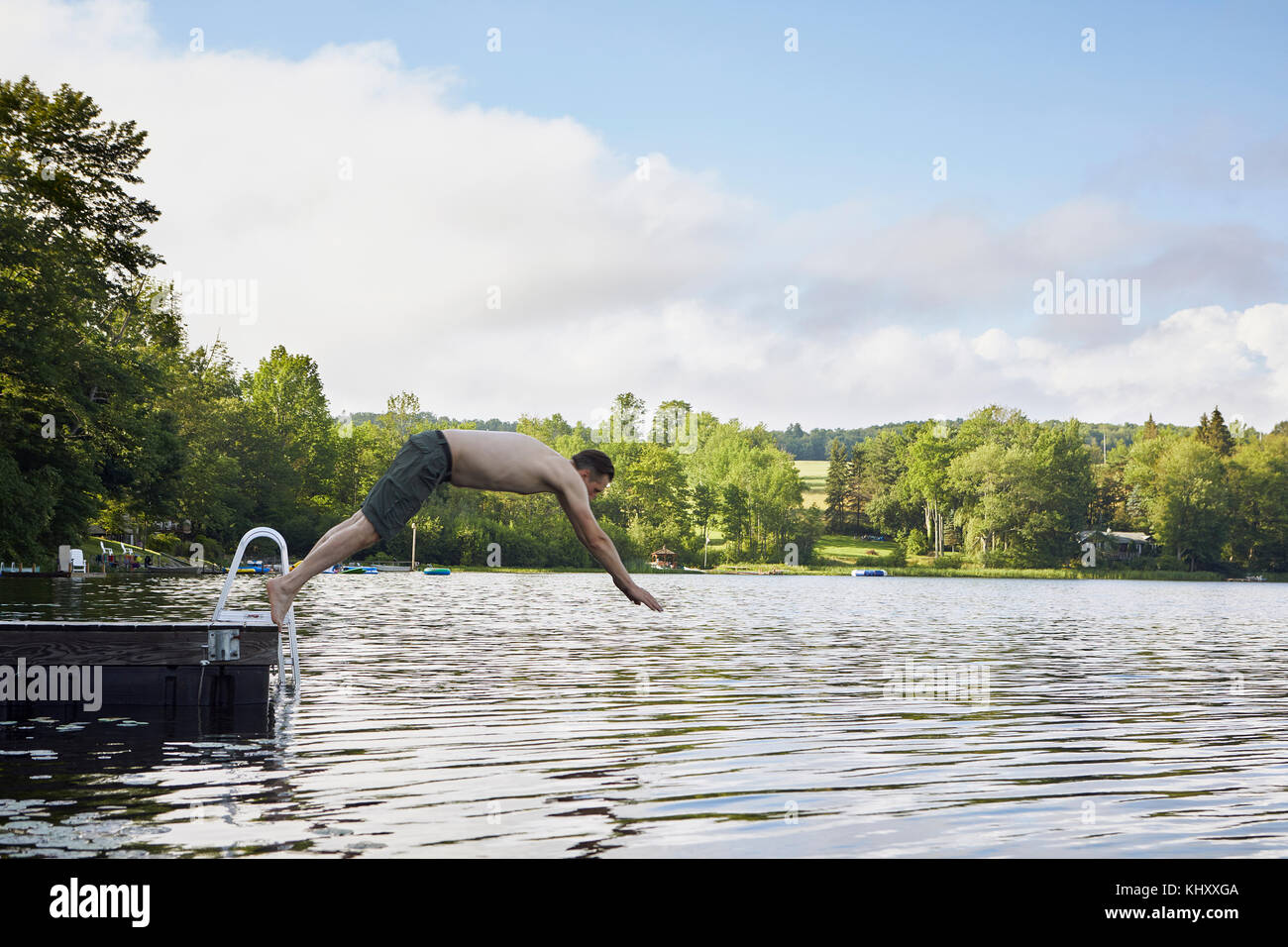 Mature man diving into lake Stock Photo Alamy