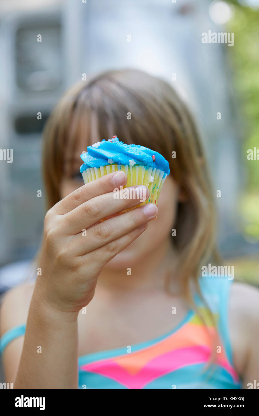 Young girl holding cupcake Stock Photo Alamy