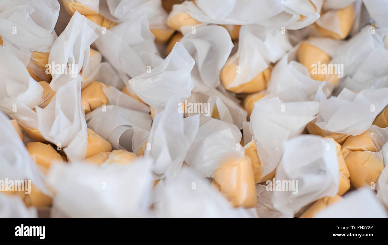 Stack of salt water taffy, delicious and chewy, wrapped in waxed paper