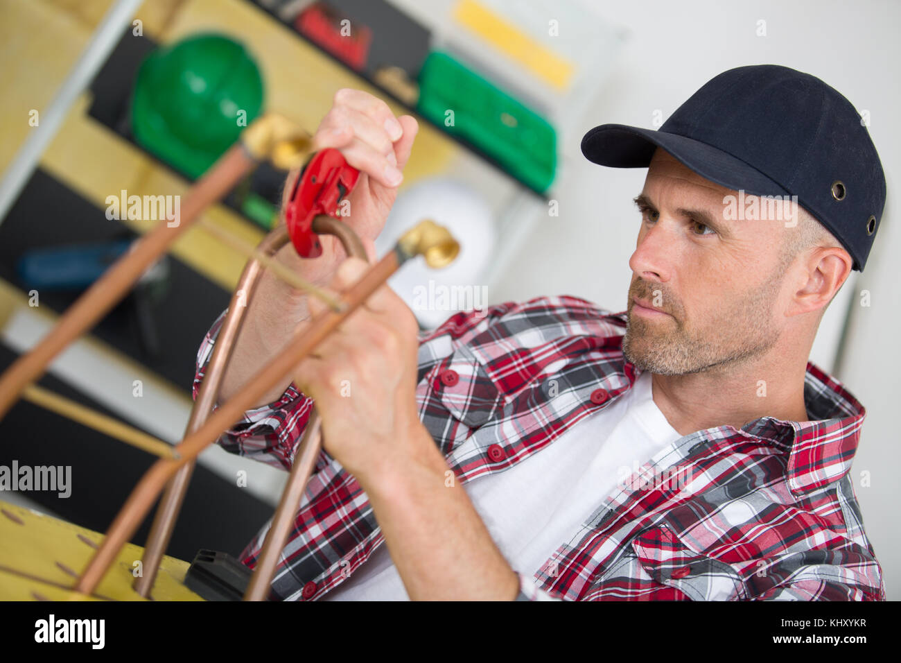 industrial worker using propane gas torch for soldering copper pipes