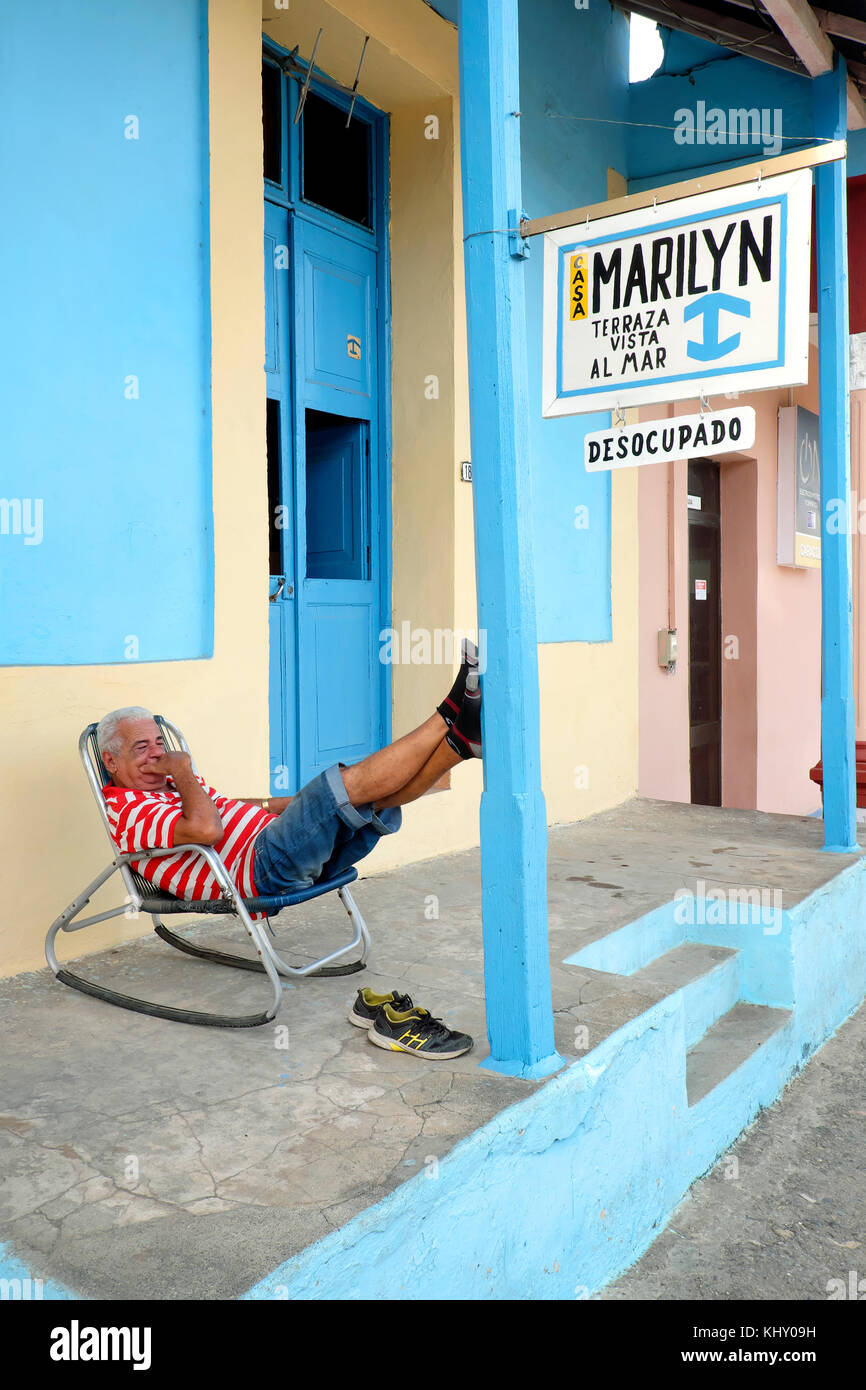 Elderly man sleeping in front of the Casa Marilyn B&B, Baracoa, Guantánamo Province, Cuba Stock Photo