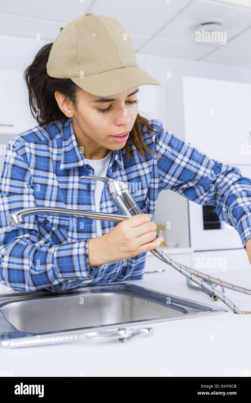 Plumber installing new tap Stock Photo Alamy