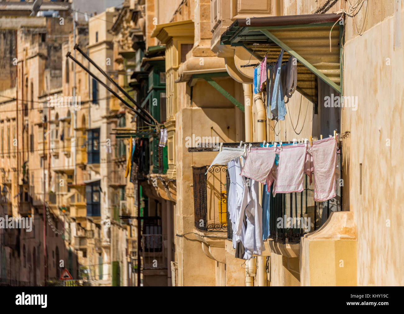 laundry hanging from a balcony on a maltese street Stock Photo