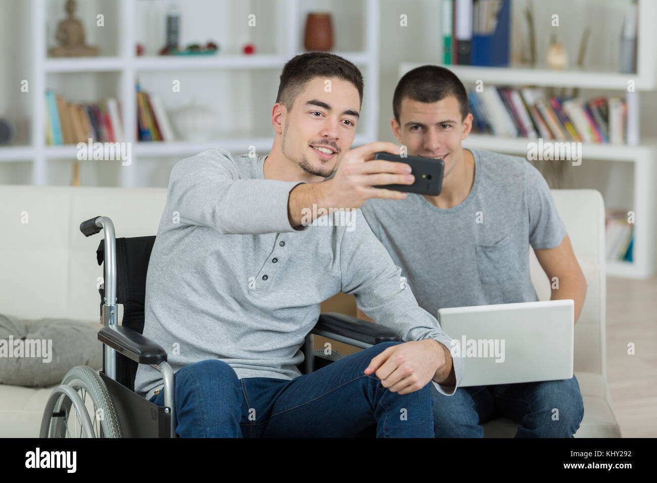 young man in a wheelchair taking a selfie with friend Stock Photo - Alamy