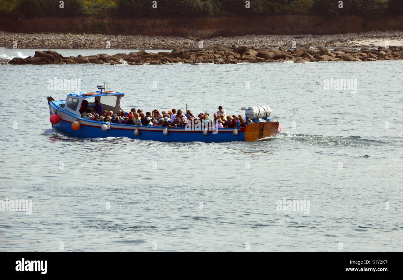 The Pleasure Boat (Guiding Star) Full of Tourists Leaving Hugh Town Harbour on the Island of St Marys in the Isles of Scilly, United Kingdom. Stock Photo