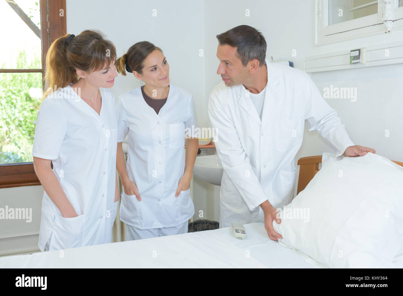 Nurses learning how to make hospital bed Stock Photo Alamy