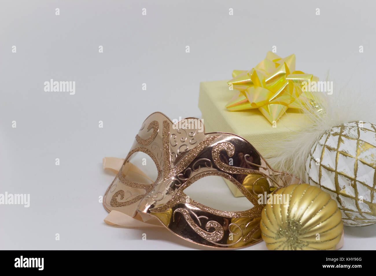 Gold mask and gift box on the table Stock Photo