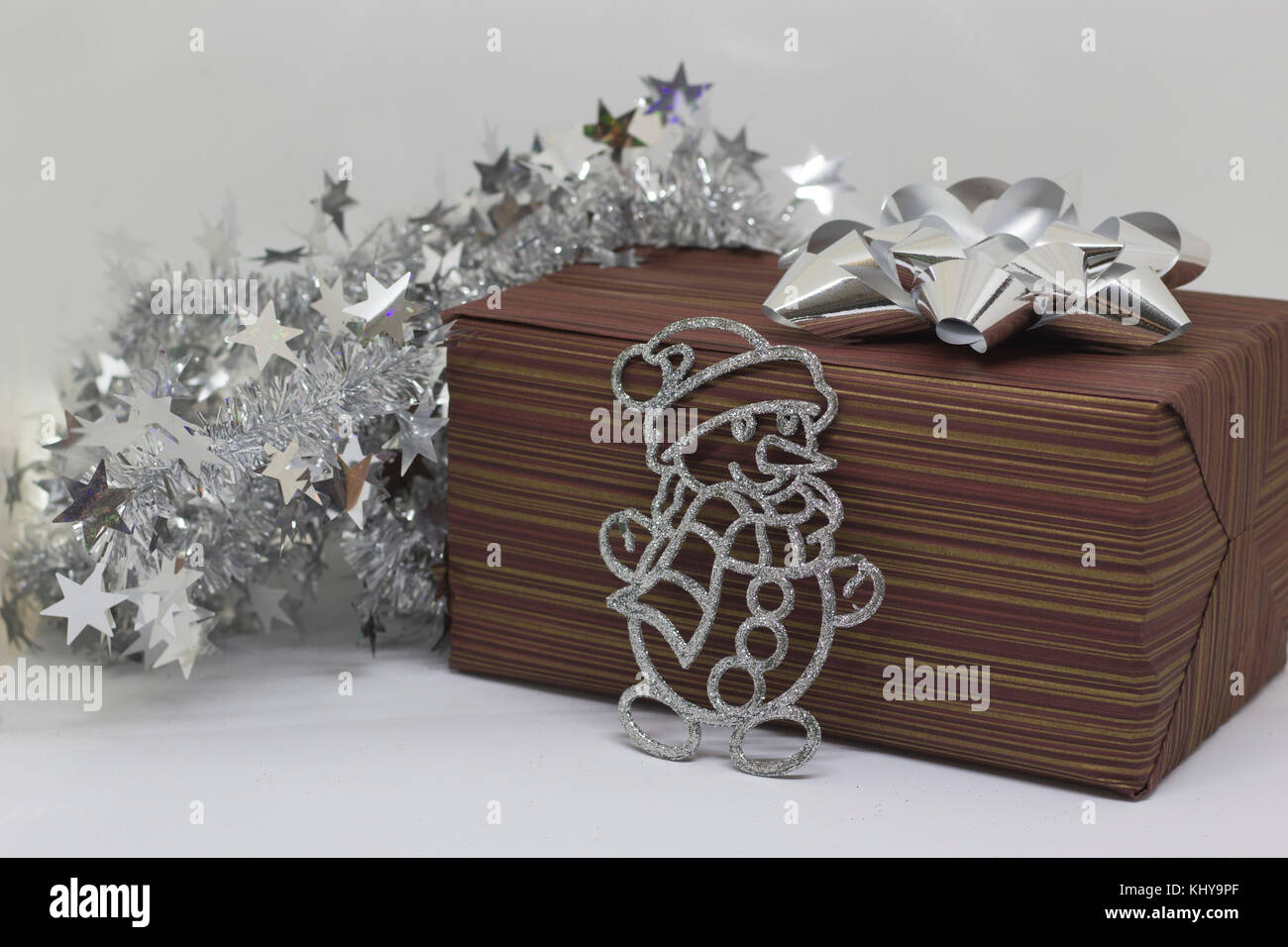 Brown box with a gift and a snowman on a light background Stock Photo ...