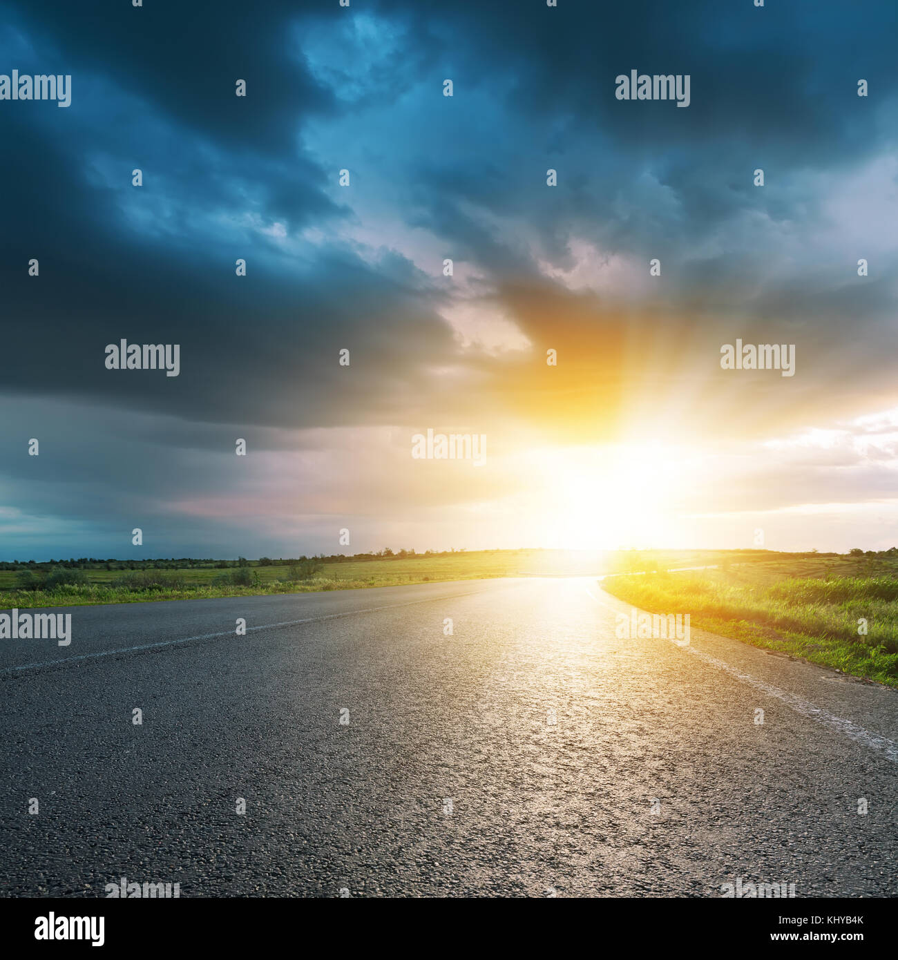 low dark clouds and yellow sunset over asphalt road Stock Photo - Alamy
