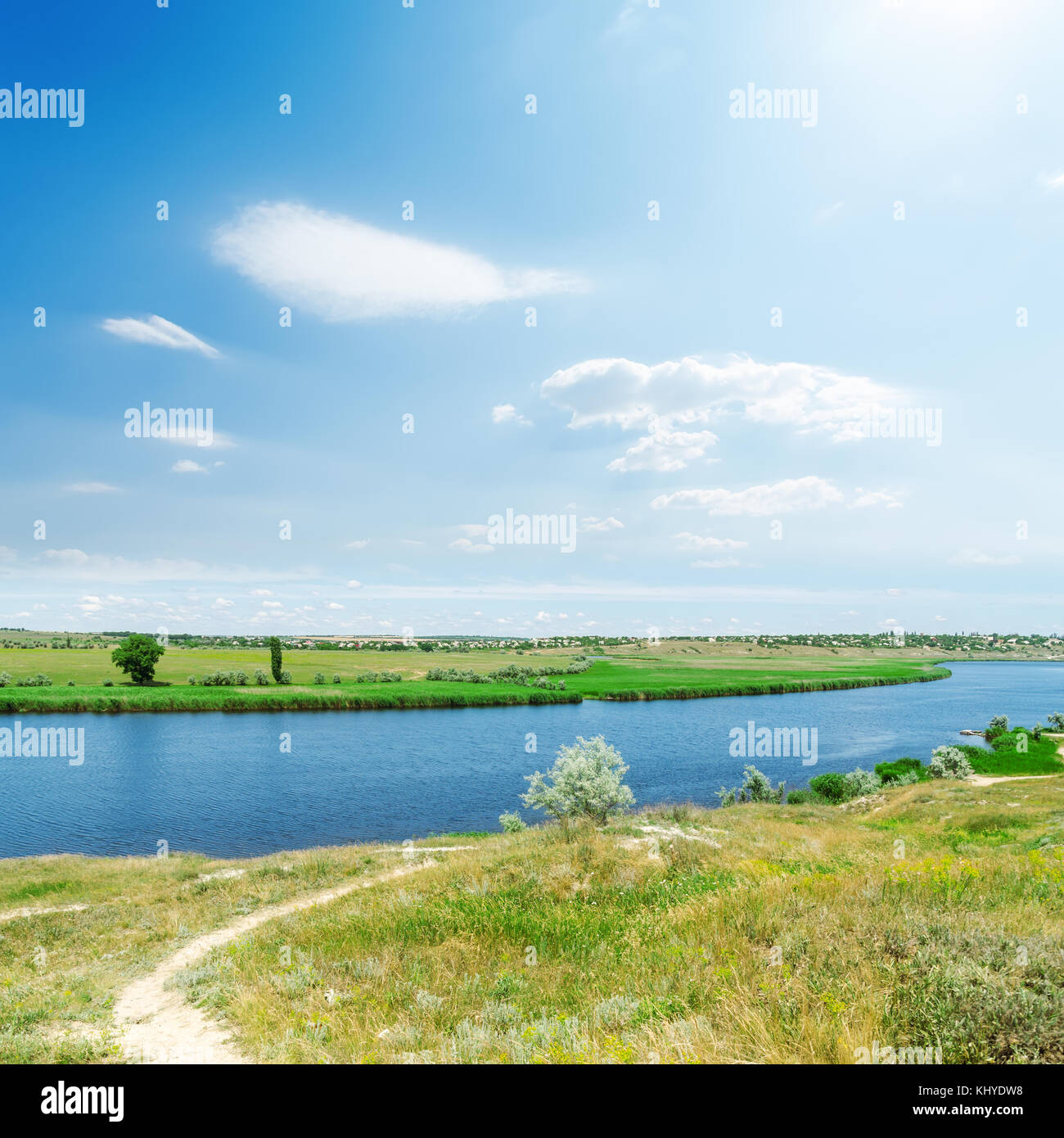 river and green landscape, blue sky with sun and clouds Stock Photo - Alamy