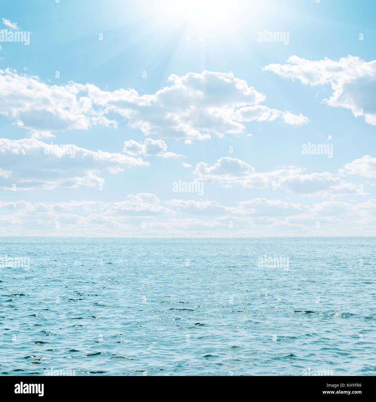 blue sea and sky with clouds and sun Stock Photo - Alamy