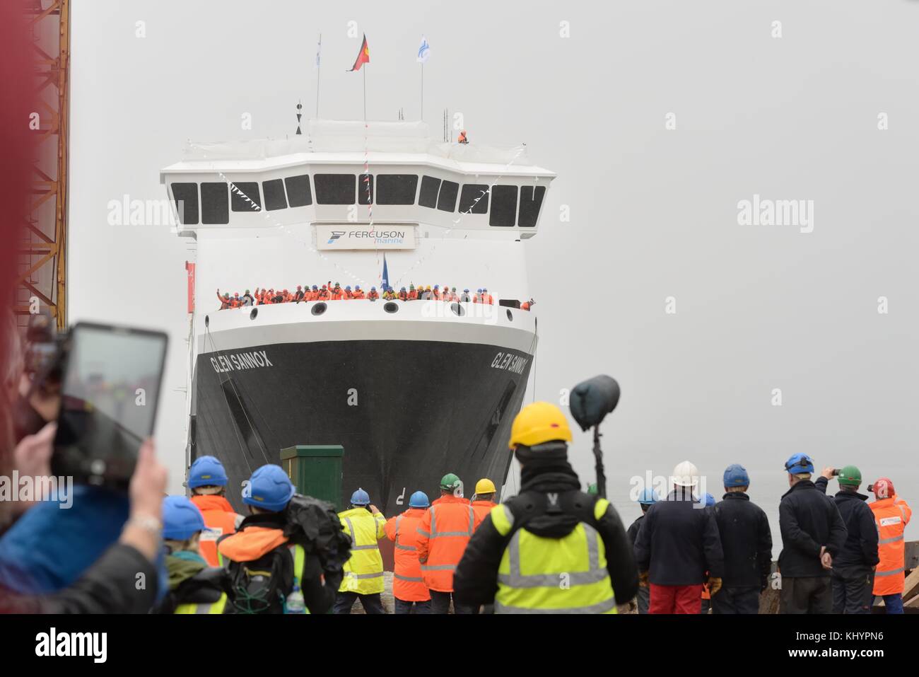 Port Glasgow, Scotland, UK. 21st Nov, 2017. The public, dockers and ship builders at Ferguson Marine in Port Glasgow watch on in the pouring rain as First Minister, Nicola Sturgeon launches the Glen Sannox car ferry on the river Clyde. Stock Photo
