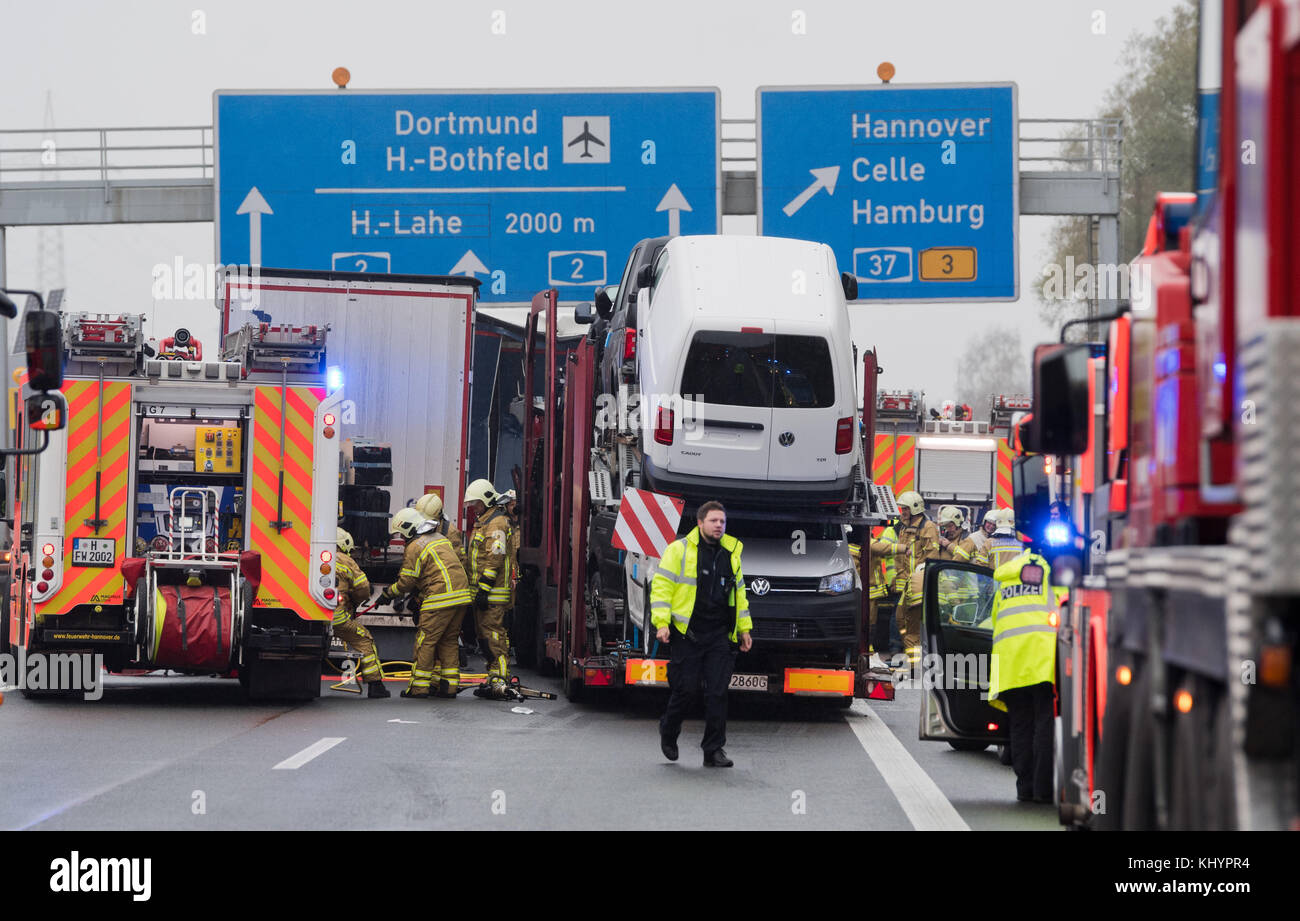 Firefighters and police officers stand on the motorway A2 after an ...