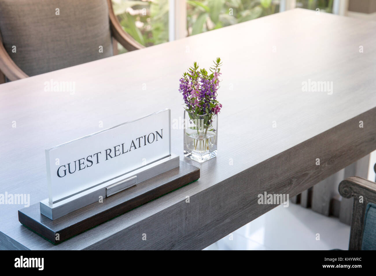 Guest acrylic sign and flower vase on the table Stock Photo