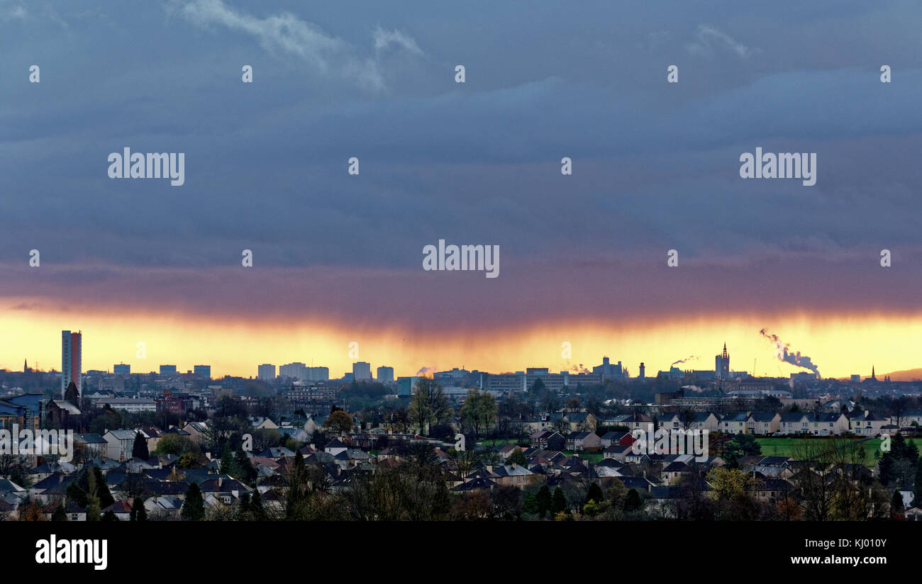 Glasgow, Scotland, UK  23rd November, 2017r. UK Weather: Torrential rain to the south east of Glasgow backlit by the rising sun of the dawn behind the black clouds . Credit Gerard Ferry/Alamy news Stock Photo