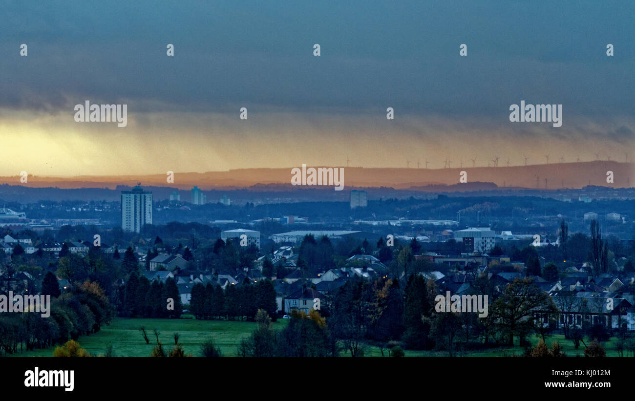 Glasgow, Scotland, UK  23rd November, 2017r. UK Weather: Torrential rain to the south east of Glasgow backlit by the rising sun of the dawn behind the black clouds . Credit Gerard Ferry/Alamy news Stock Photo