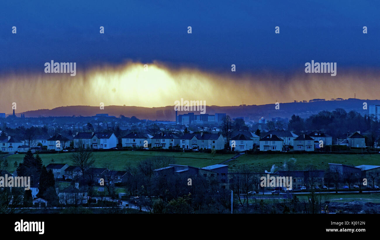 Glasgow, Scotland, UK  23rd November, 2017r. UK Weather: Torrential rain to the south east of Glasgow backlit by the rising sun of the dawn behind the black clouds . Credit Gerard Ferry/Alamy news Stock Photo