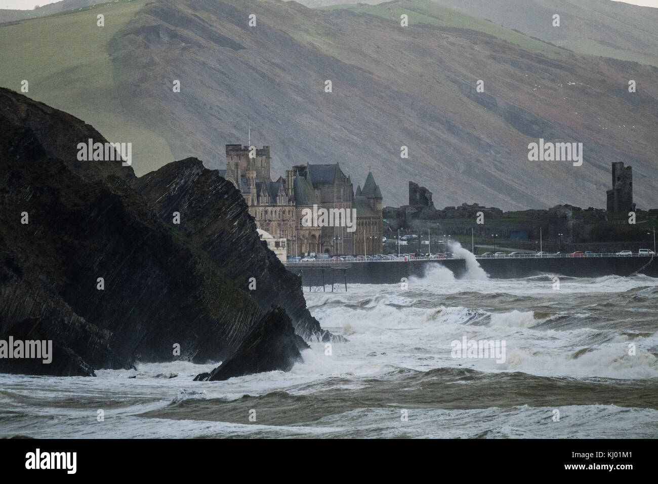 Aberystwyth Wales UK, Thursday 23 November 2017 UK Weather: High tides and very strong winds combine to bring waves crashing into the castle headland and university buildings on the promenade in Aberystwyth, on the Cardigan Bay coast of west wales. photo Credit: Keith Morris/Alamy Live News Stock Photo