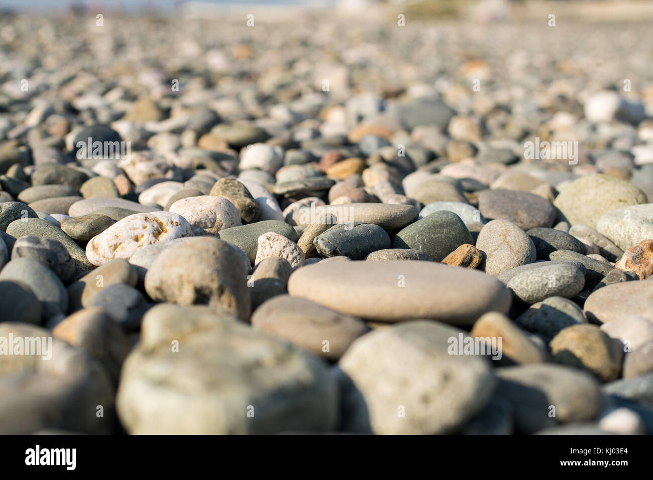 Stones on beach and sea water Stock Photo - Alamy