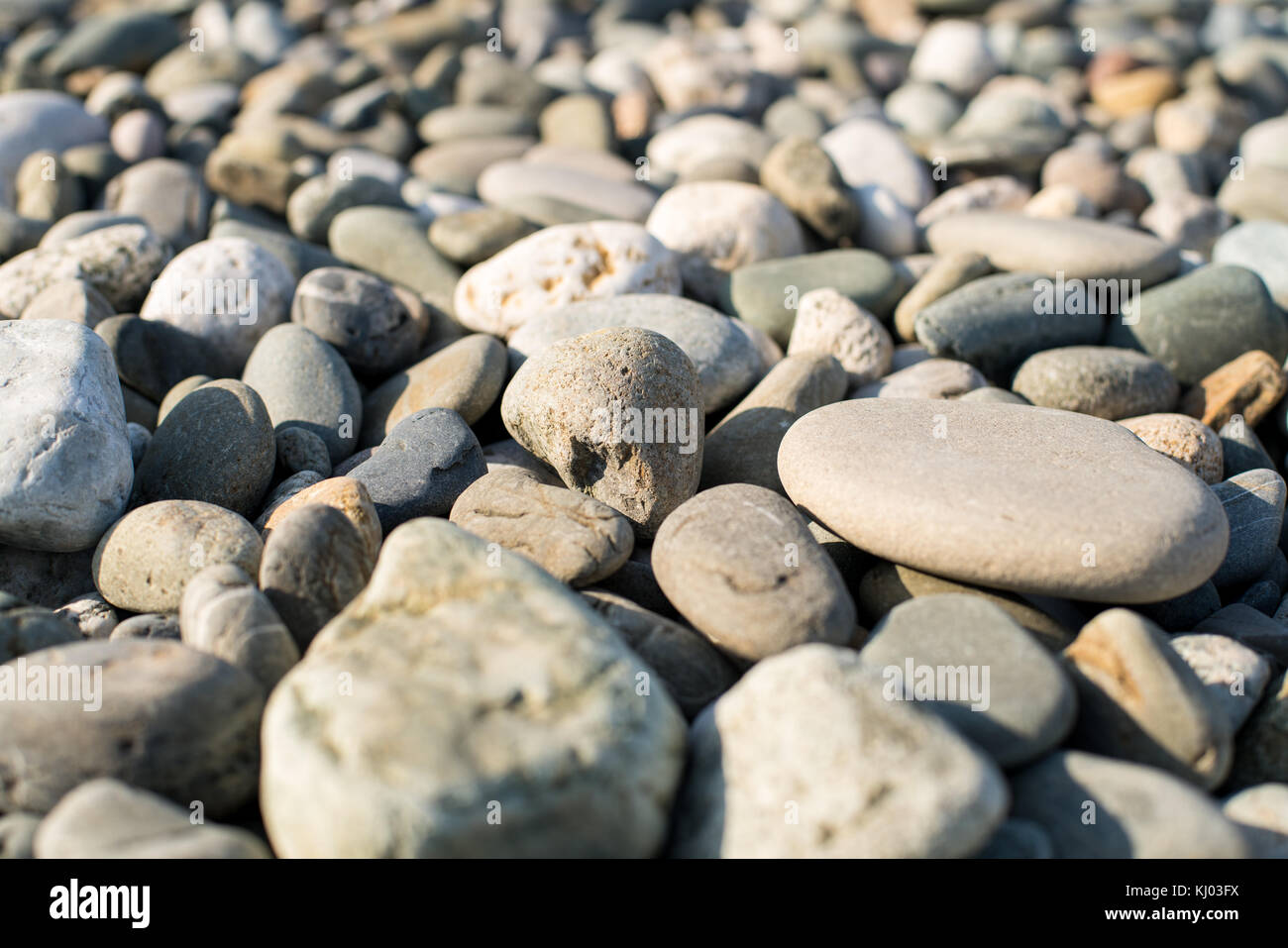 Stones on beach and sea water Stock Photo - Alamy