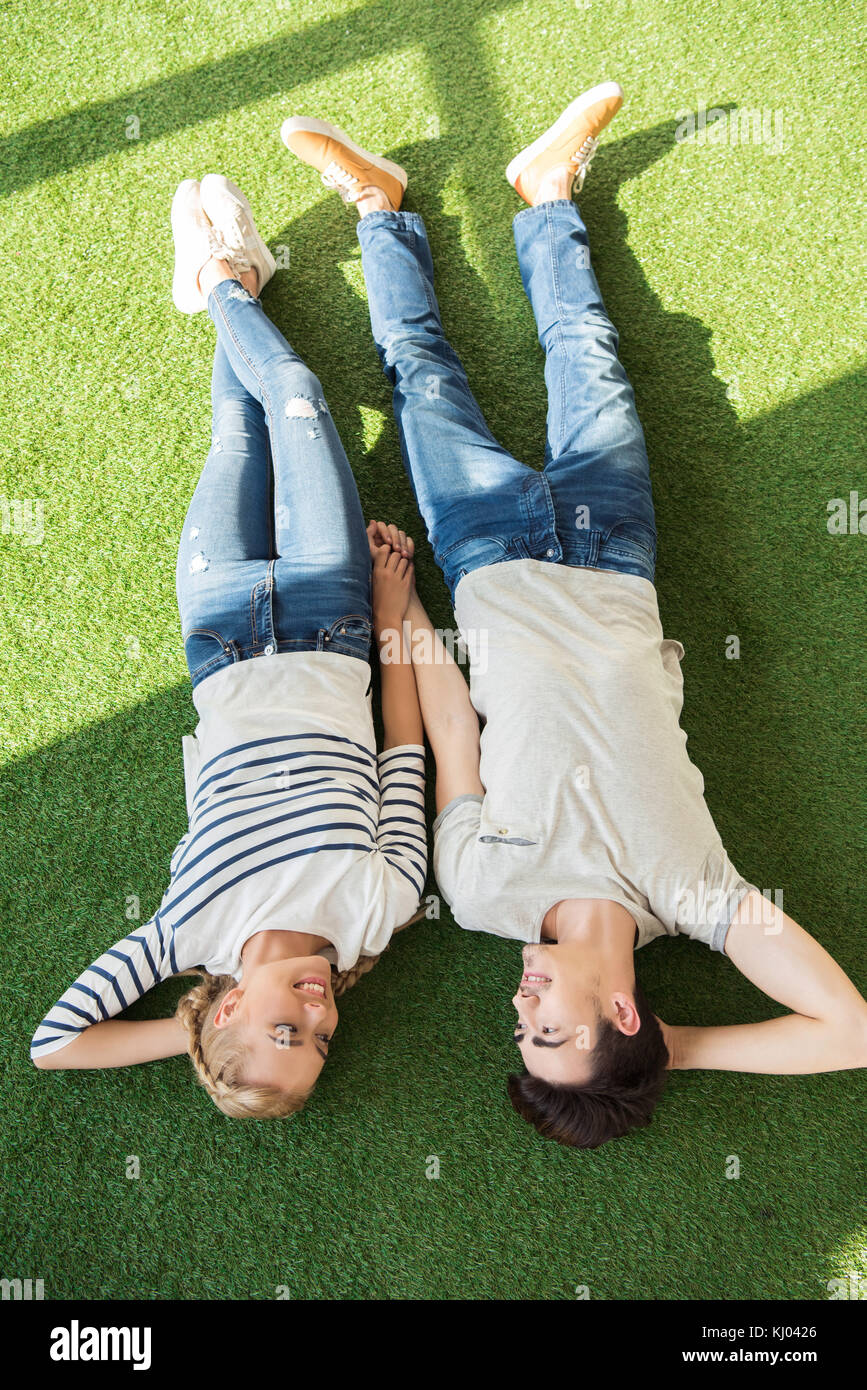 happy young couple on grass Stock Photo - Alamy