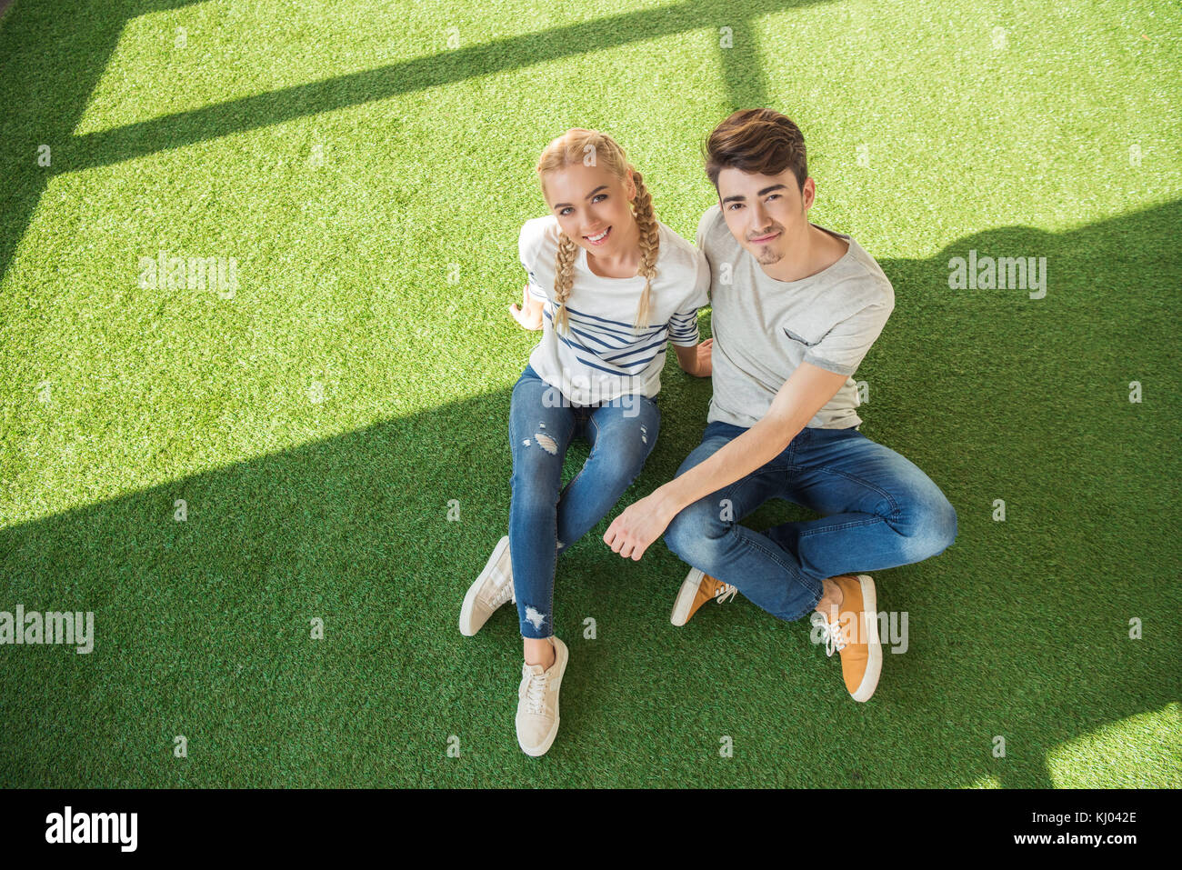 happy young couple on grass Stock Photo - Alamy