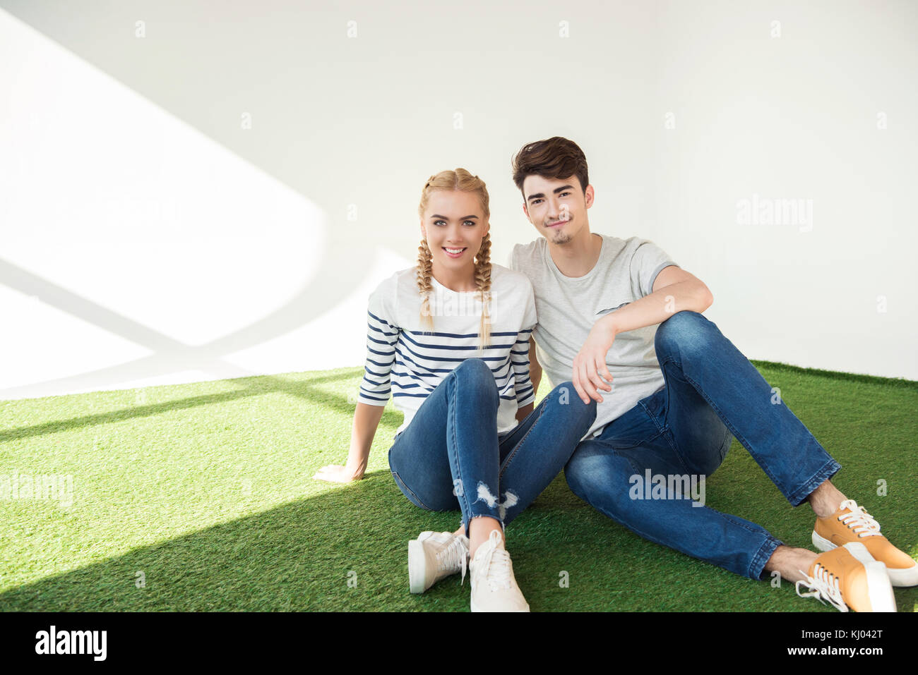 happy young couple on grass Stock Photo - Alamy