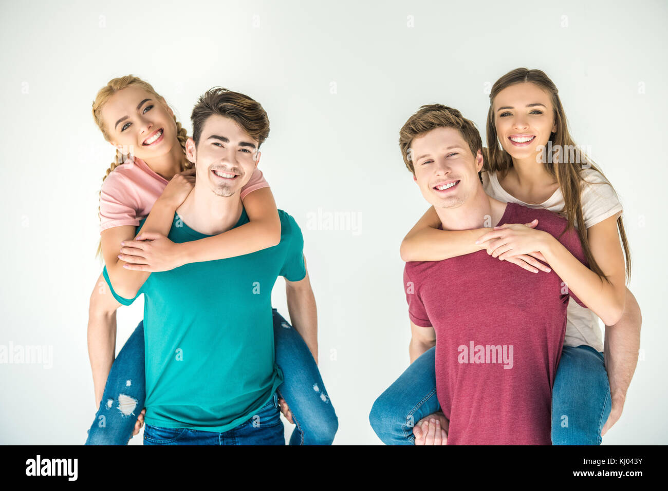 happy young friends piggybacking  Stock Photo