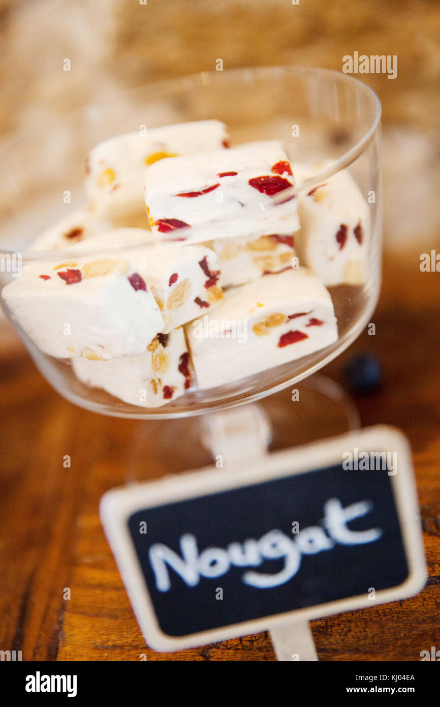 Cubes of nougat in drinking glass and handwritten label, close up Stock Photo