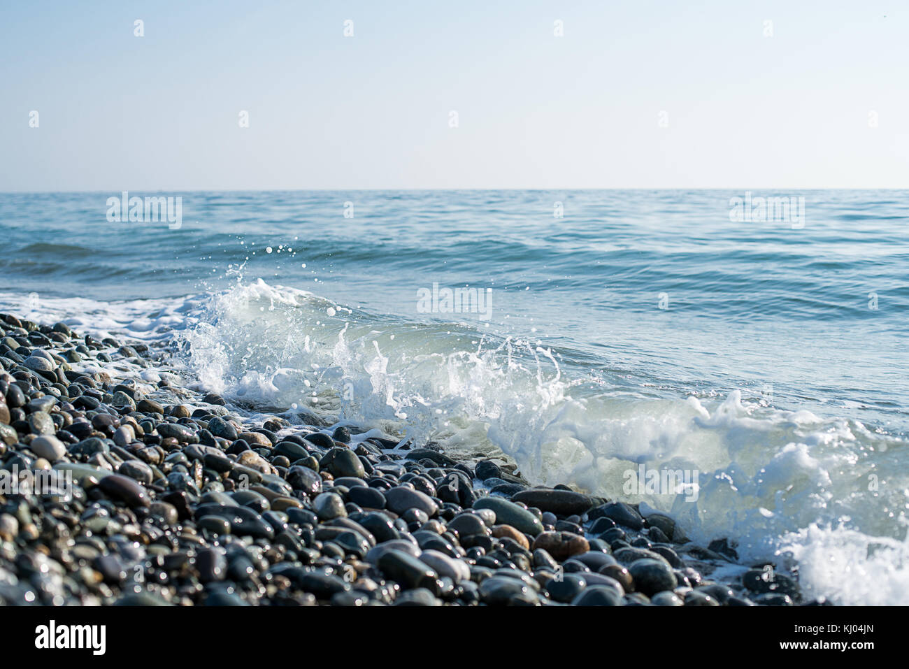 Stones on beach and sea water Stock Photo - Alamy