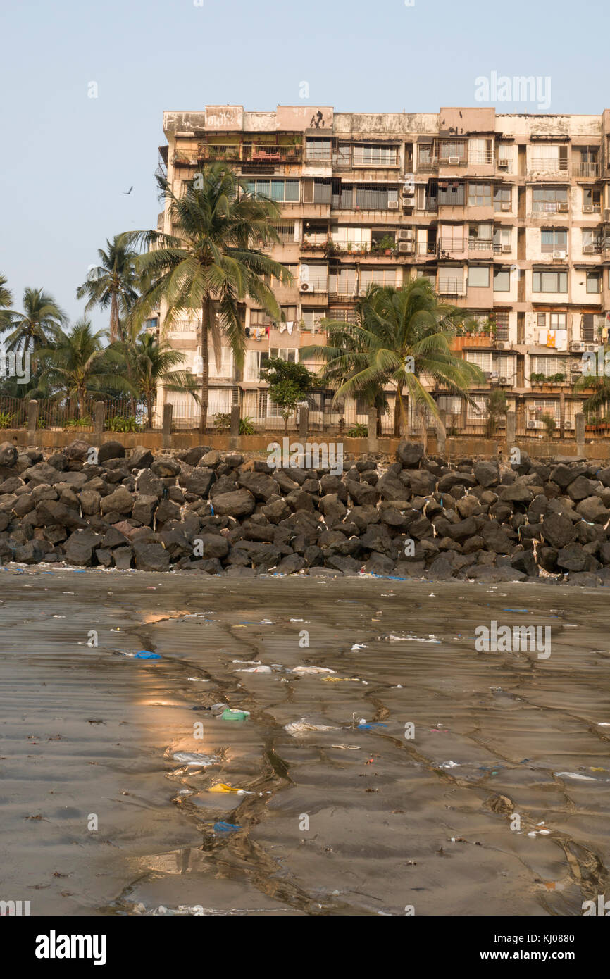 Seafront apartment building at plastic garbage covered Versova beach