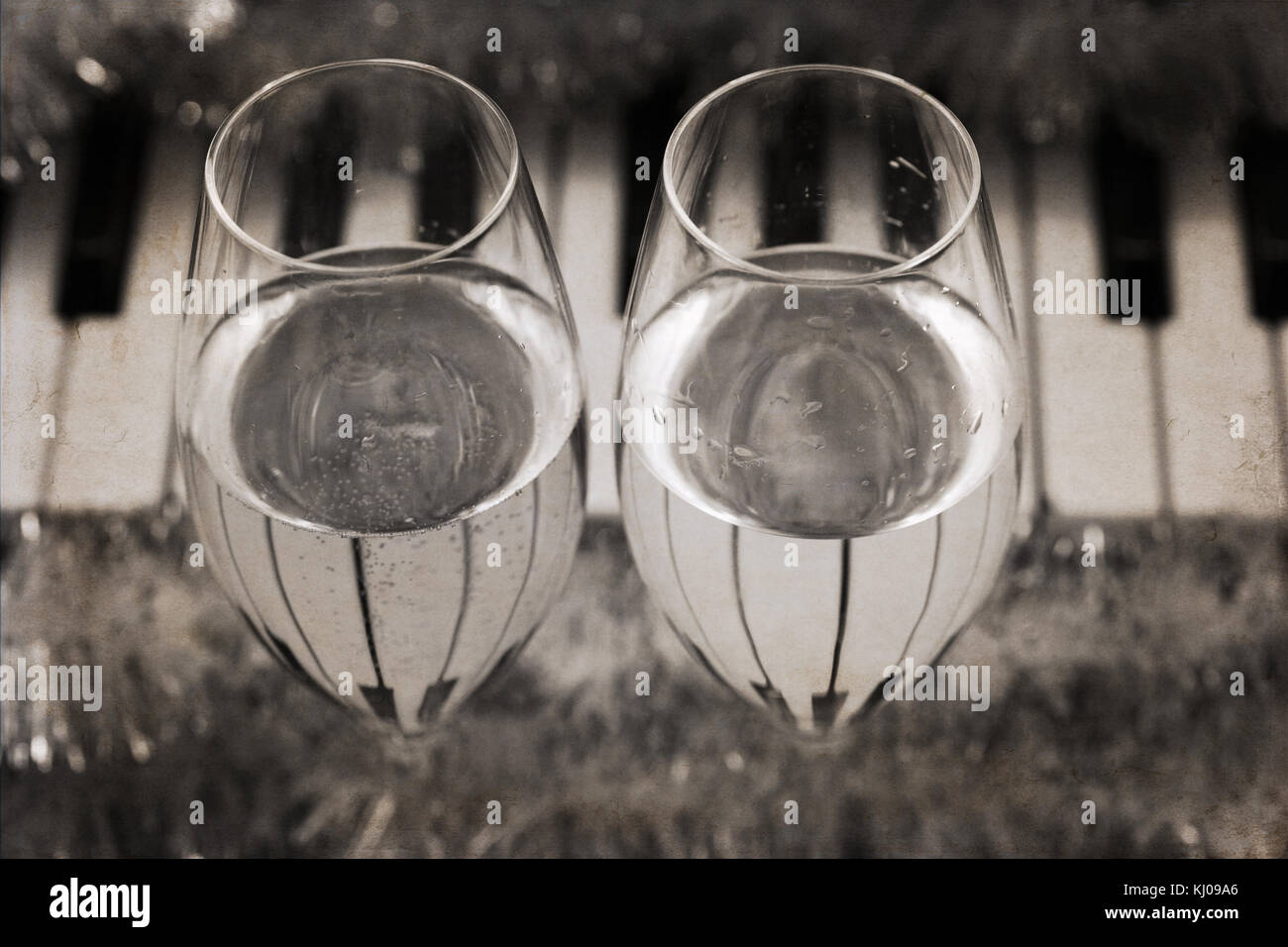 Artwork in vintage style, reflection of piano keys in two wine glasses