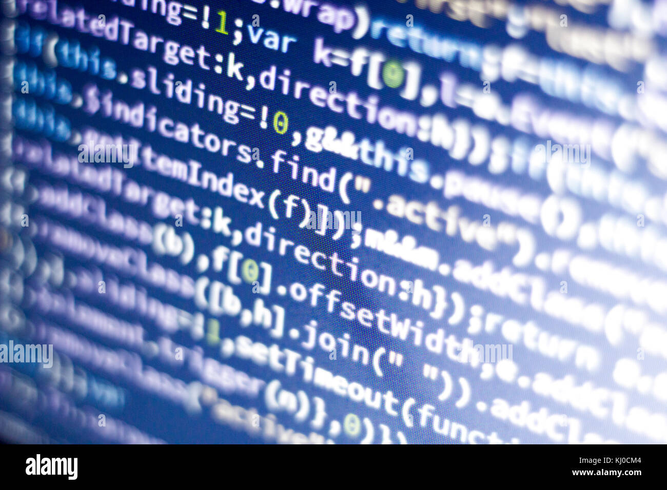 Glowing minificated javascript code. Abstract screen of modern web developer. Hacking computer network. Stock Photo