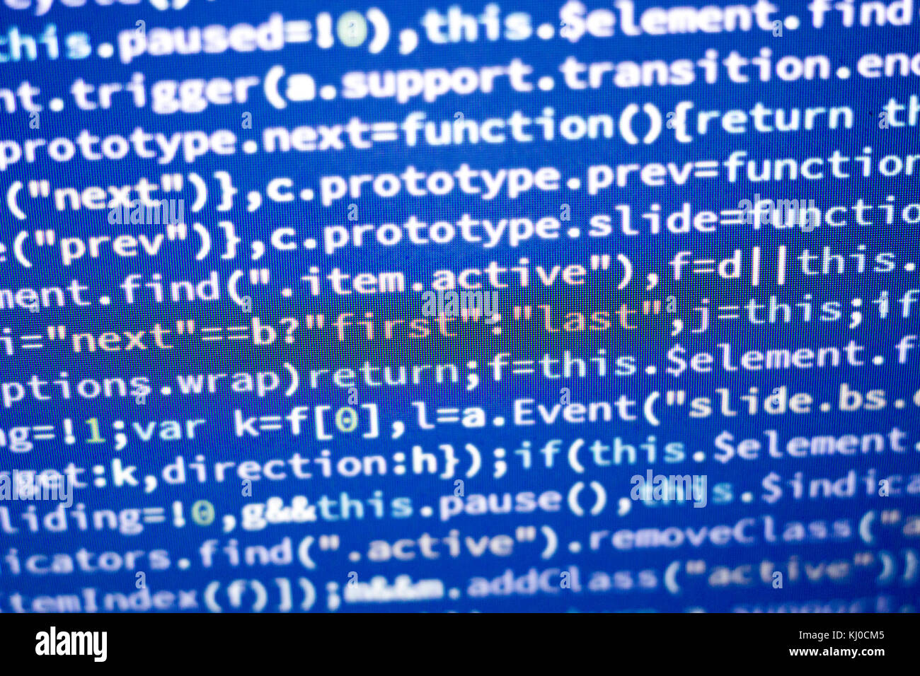 Glowing minificated javascript code. Abstract screen of modern web developer. Hacking computer network. Stock Photo