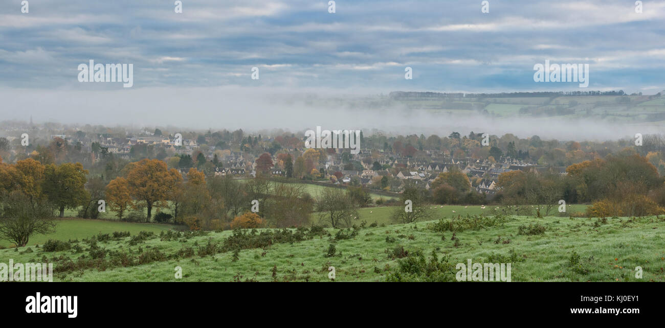 Early morning autumn mist over Bourton on the Water, Cotswolds, Oxfordshire, England. Panoramic Stock Photo