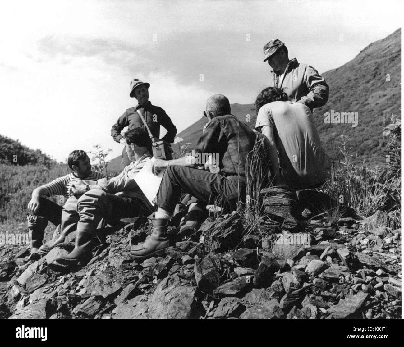 Group photo of men in the field while making a break between work Stock Photo