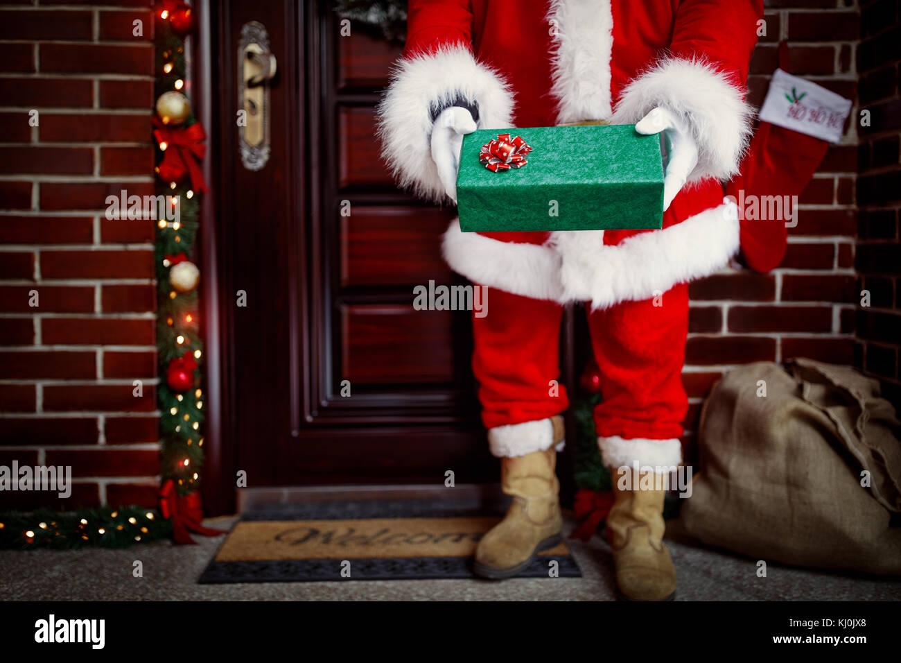 Santa Claus carrying gifts to happy children Stock Photo - Alamy