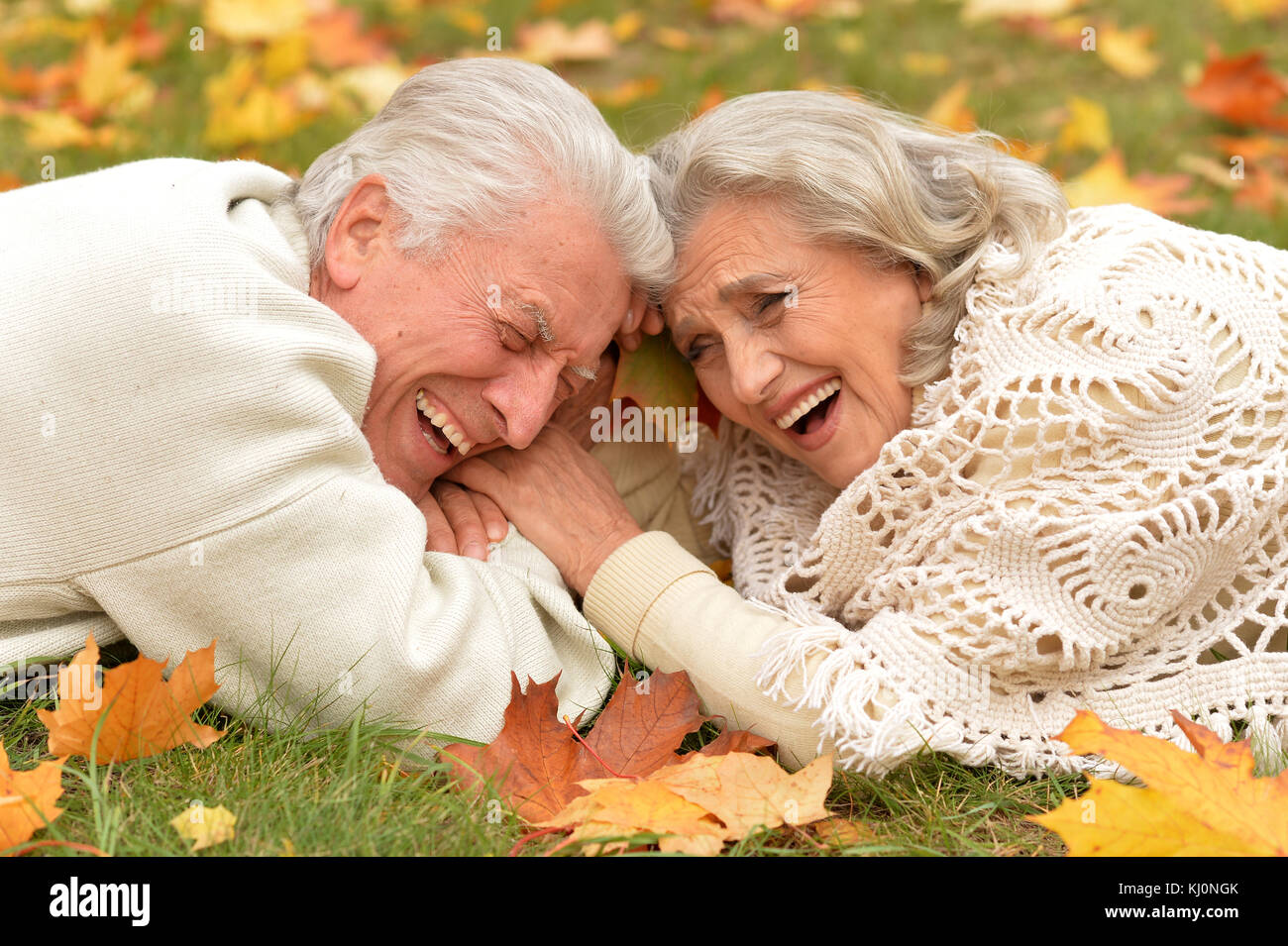 couple in autumn park lying Stock Photo - Alamy