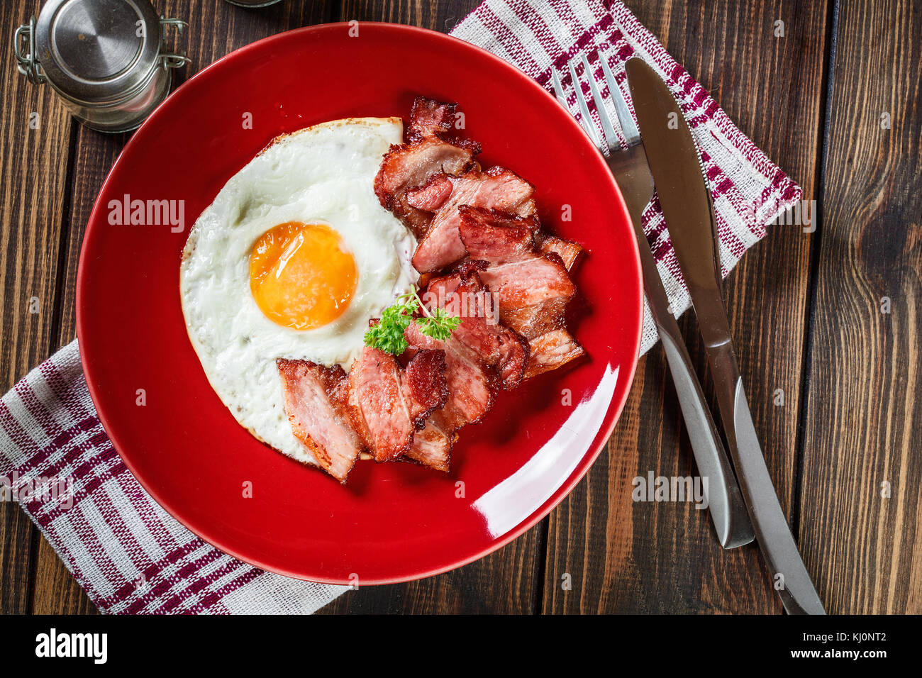 Slices Of Smoked Bacon And Fried Egg On A Red Plate Eating Habits