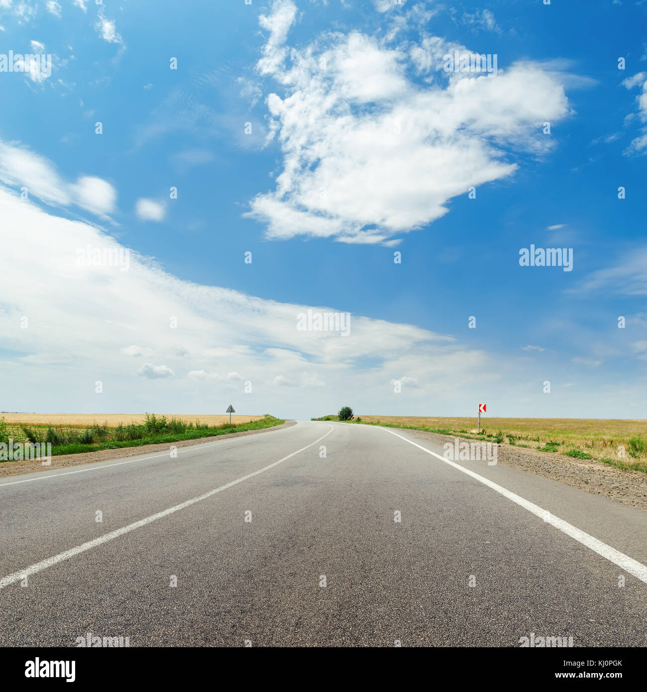 asphalt road to horizon and blue sky with clouds over it Stock Photo ...