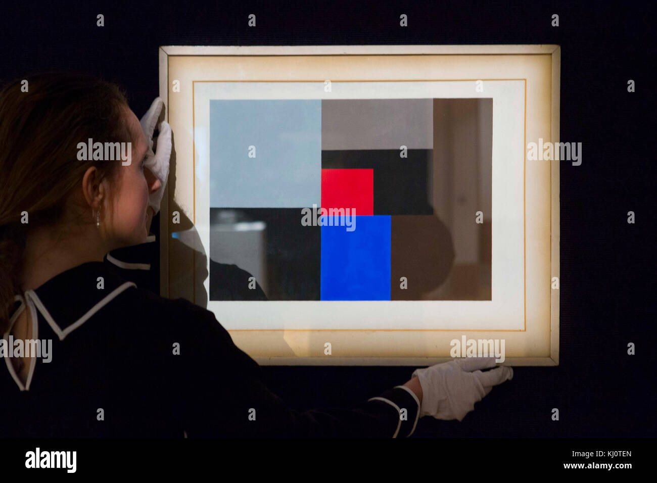A member of staff looks at '1936 (gouache)' by Ben Nicholson (est. £150,000 - 200,000) which forms part of Bonhams' forthcoming Modern British and Irish Art Sale in London. Stock Photo