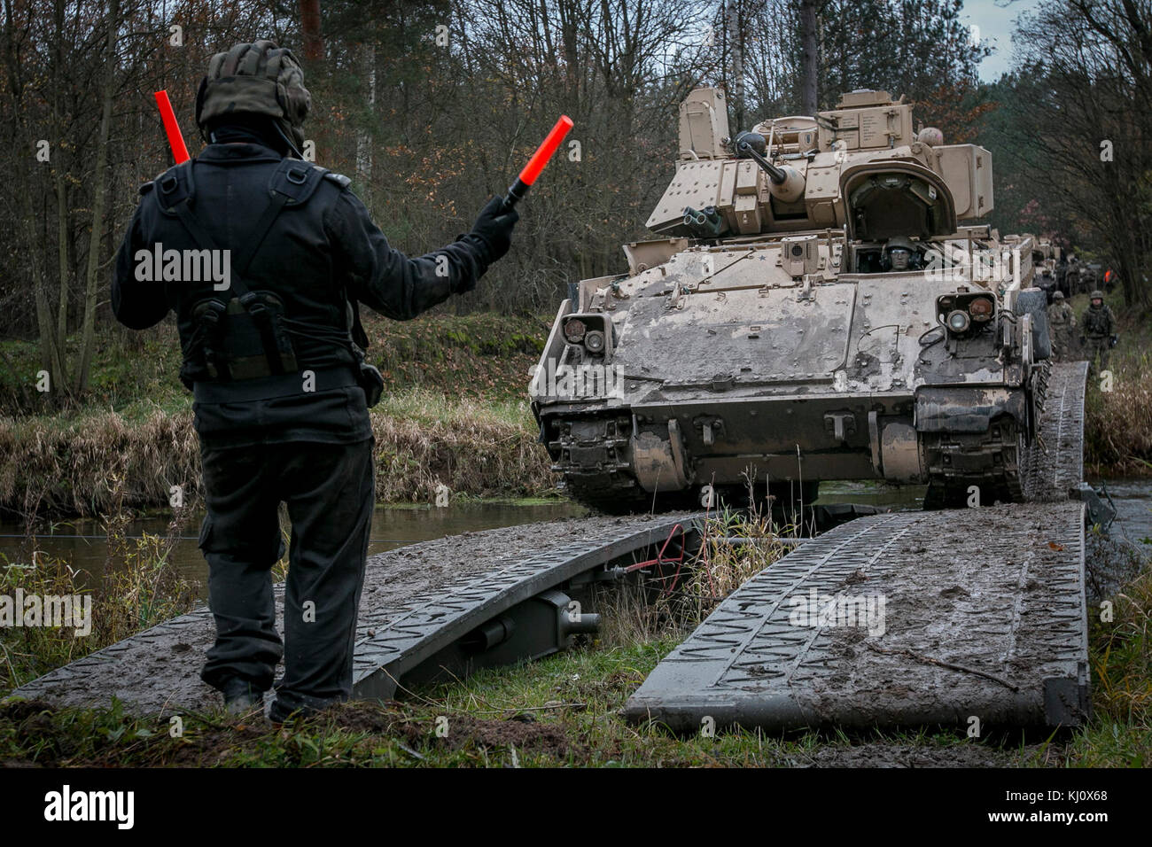Poland Rotation Fort Riley A ground guide from the Polish 10th Armored Cavalry Brigade guides a U ...