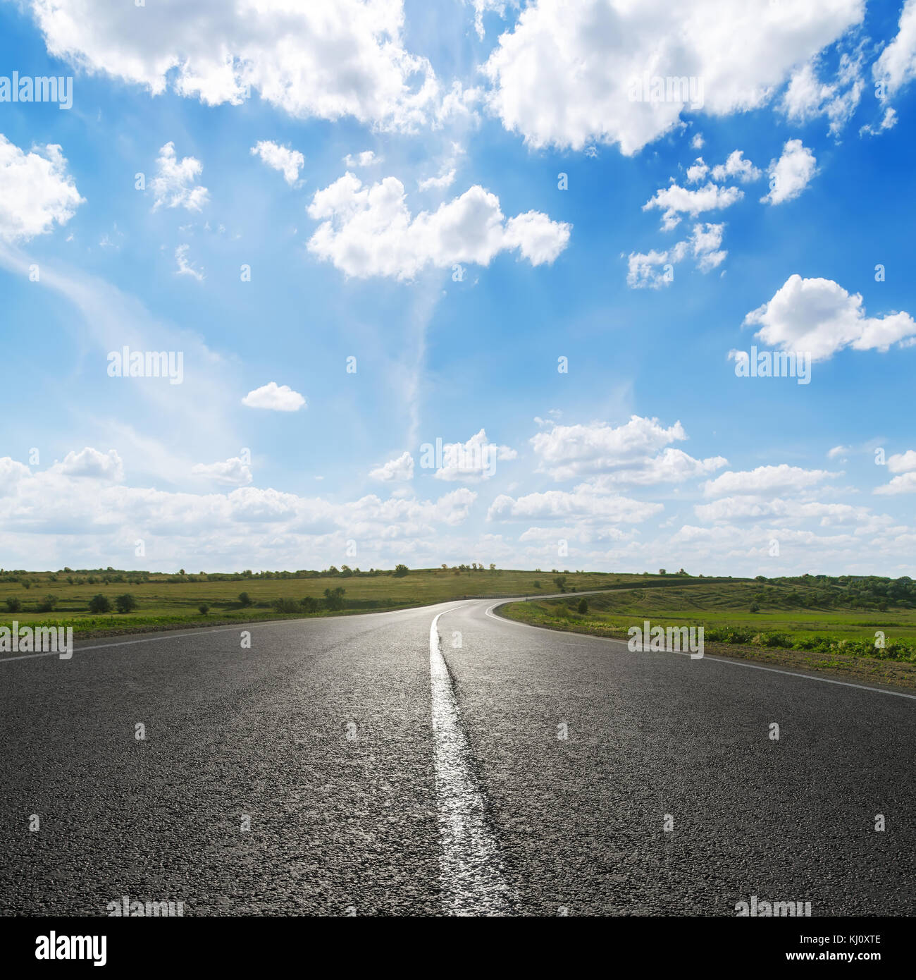 blue sky with white clouds over asphalt road Stock Photo - Alamy