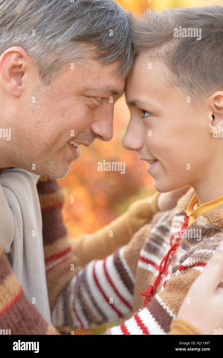 Father and son in autumn park Stock Photo - Alamy