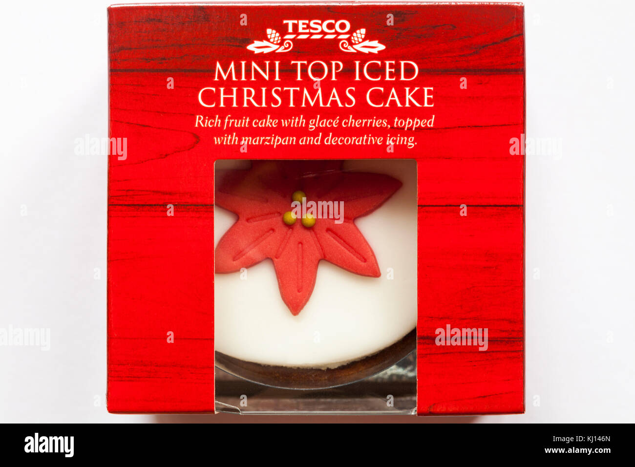 Tesco mini top iced Christmas cake - rich fruit cake with glace cherries, topped with marzipan and decorative icing set on white background Stock Photo